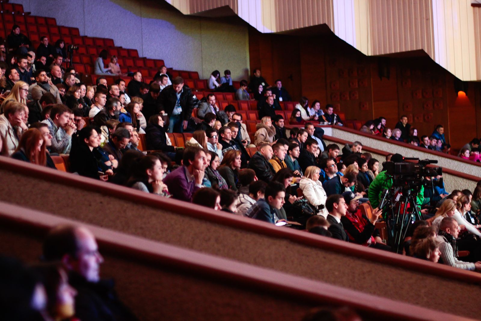 A full room at a conference, seen from the back
